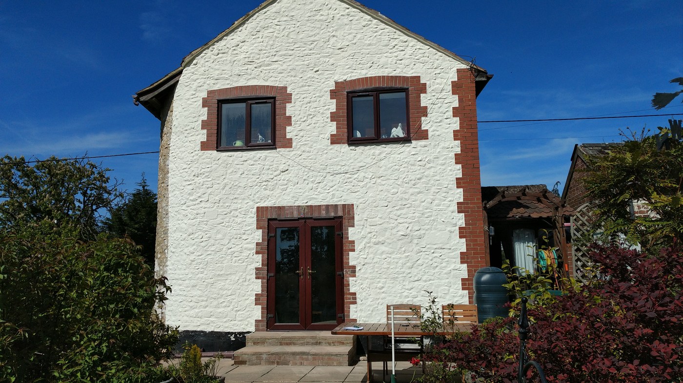 A traditional country home after a finished ProPERLA wall coating